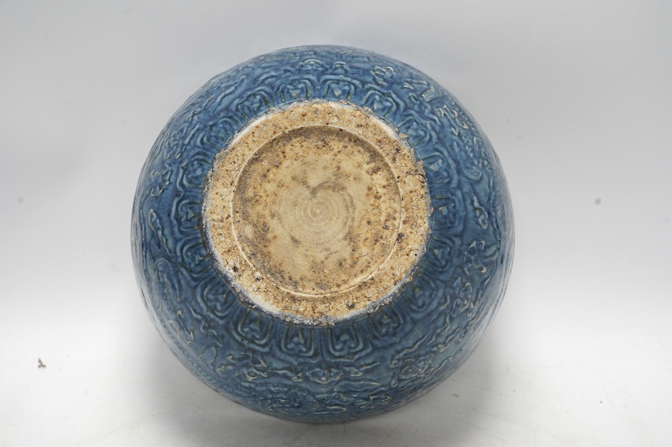 A large Chinese blue and white ‘dragon’ bowl decorated in low relief, 28cm in diameter. Condition - good